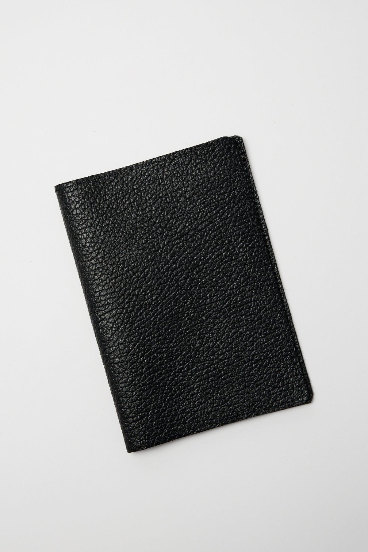 Black textured leather passport cover displayed at an angle on a light background.