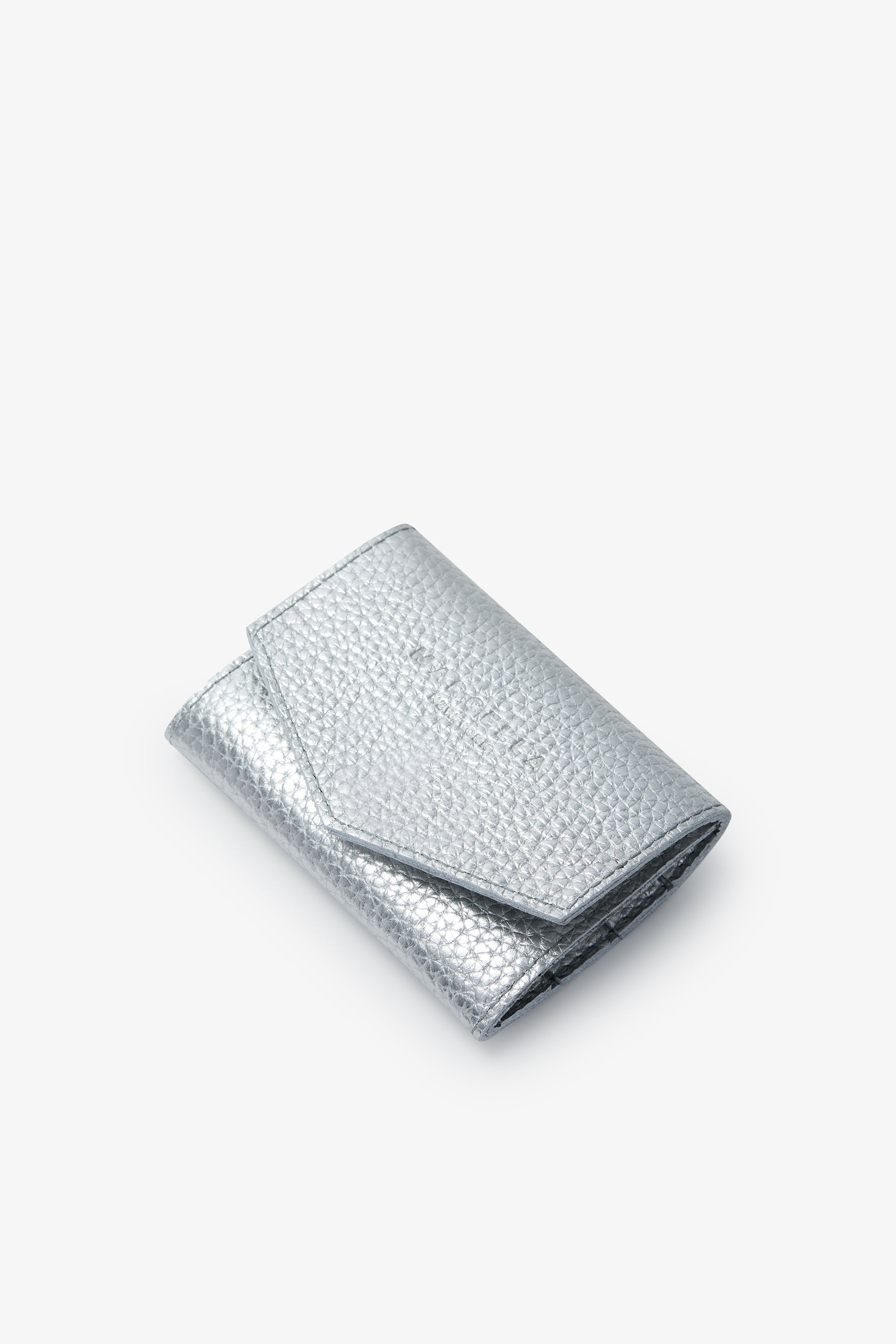 Silver metallic jewelry pouch with textured quilted surface and fold-over flap closure.
