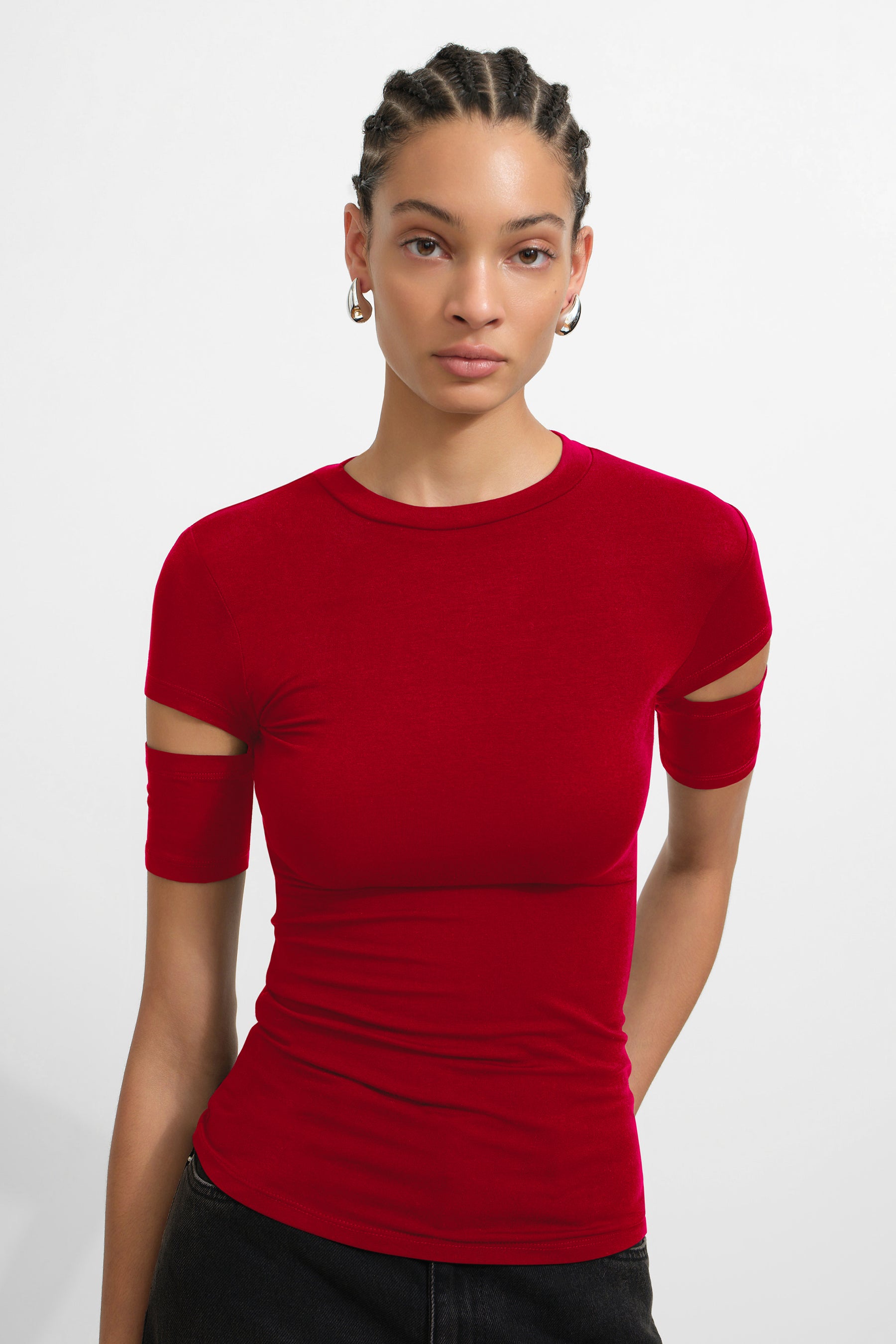 Red fitted top with short sleeves featuring cutout details on the arms and crew neckline.